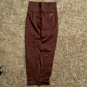 These are red brown leggings from Gymshark in the size xtra small